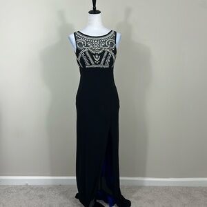 Elegant black evening gown with intricate beadwork, a high slit Size 5/6